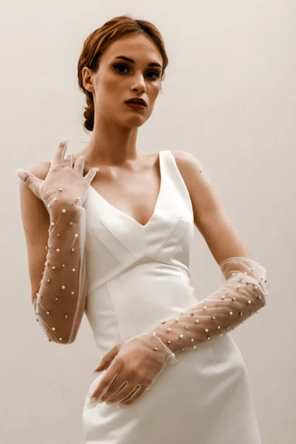 Bridal accessories bridal wedding gloves accessories by Heirloom. Bride posing in her bridal gloves by Heirloom Toronto bridal shop White Lace Bridal Couture. Canada & USA